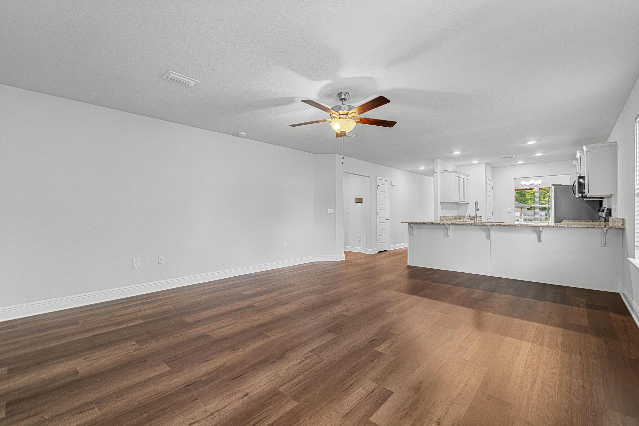 103 Ridgeway Circle Crestview, FL 32536 - Photo 10 of 33 a view of an empty room with kitchen and window