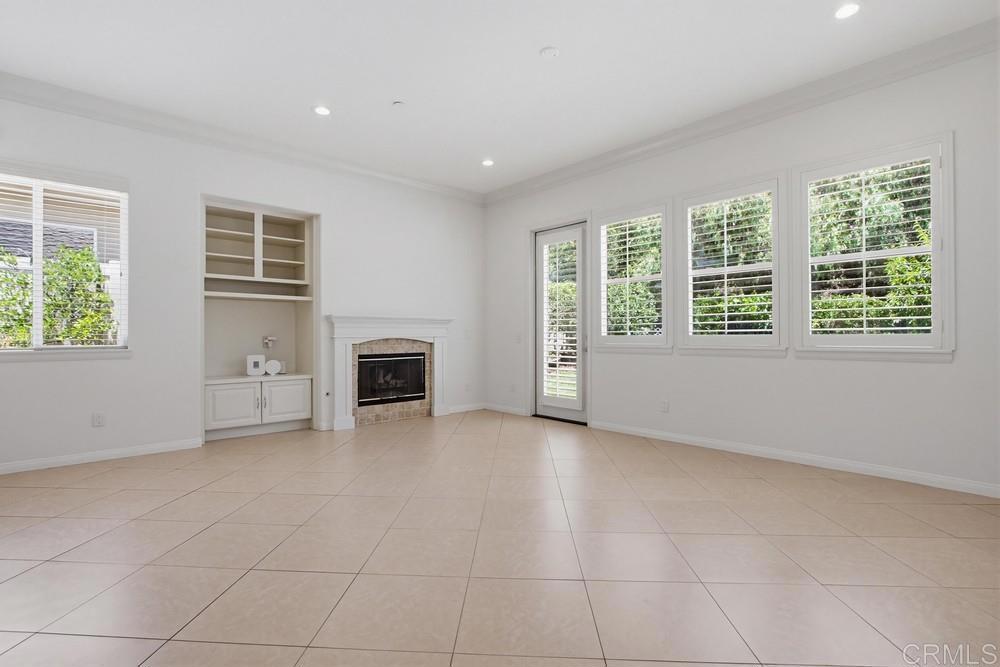 672 Inverlochy Drive Fallbrook, CA 92028 - Photo 24 of 75 a view of an empty room with a window and fireplace