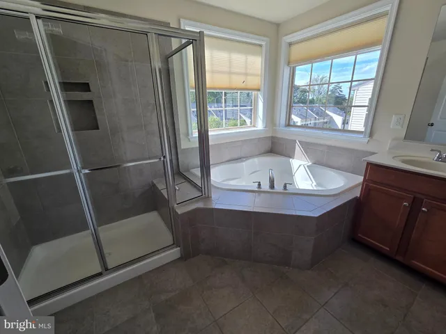 a white toilet sitting next to a white cabinet