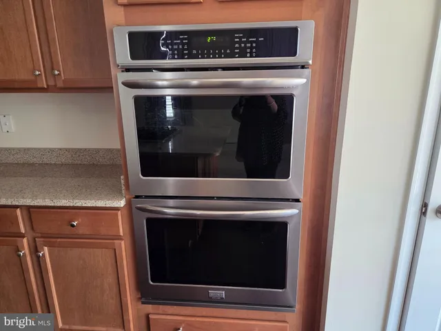 a stove top oven sitting inside of a kitchen