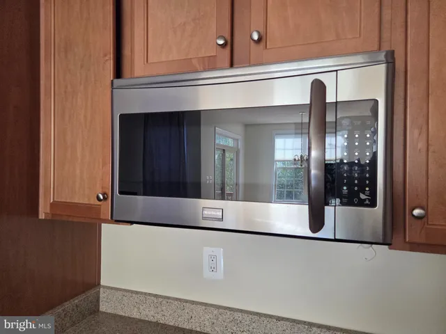 a view of kitchen with a refrigerator and cabinets