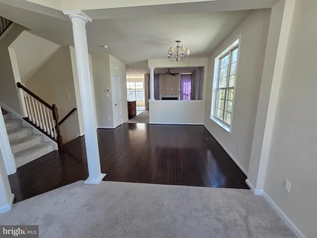 a view interior of a house with wooden floor fireplace and windows