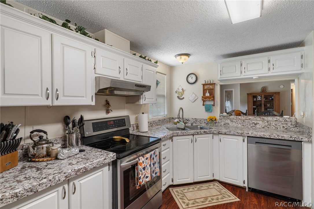 7927 West Cyprian Court Homosassa, FL 34448 - Photo 13 of 40 a kitchen with granite countertop a sink stove and cabinets