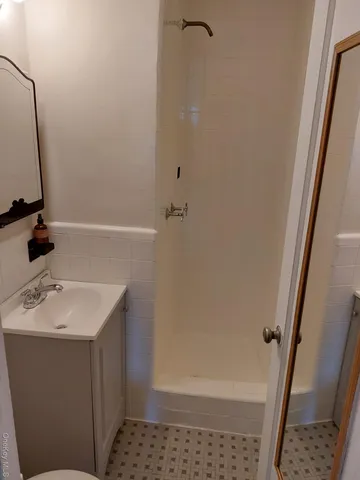 a bathroom with a sink a mirror and shower