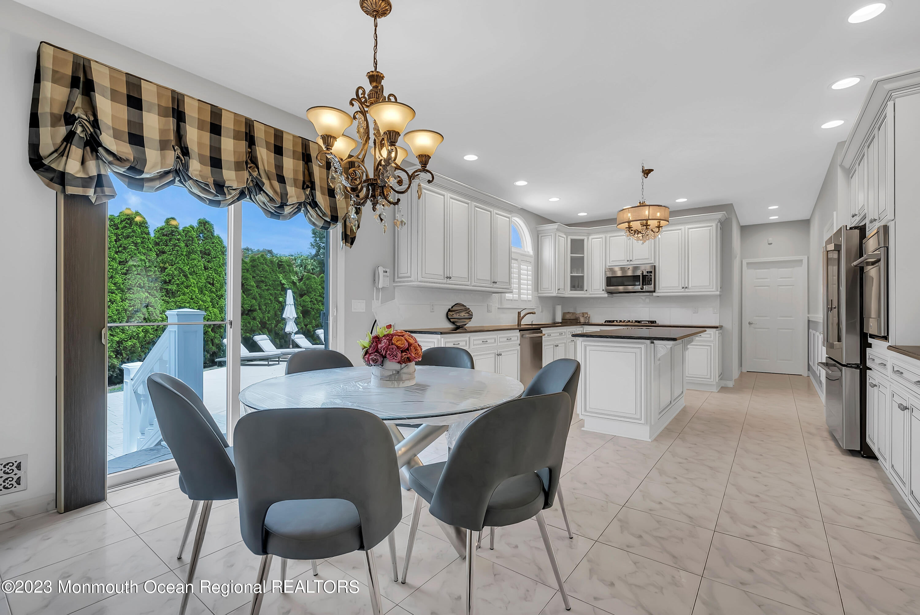 7 MacKenzie Road Eatontown, NJ 07724 - Photo 13 of 42 a view of a dining room with furniture a chandelier and window
