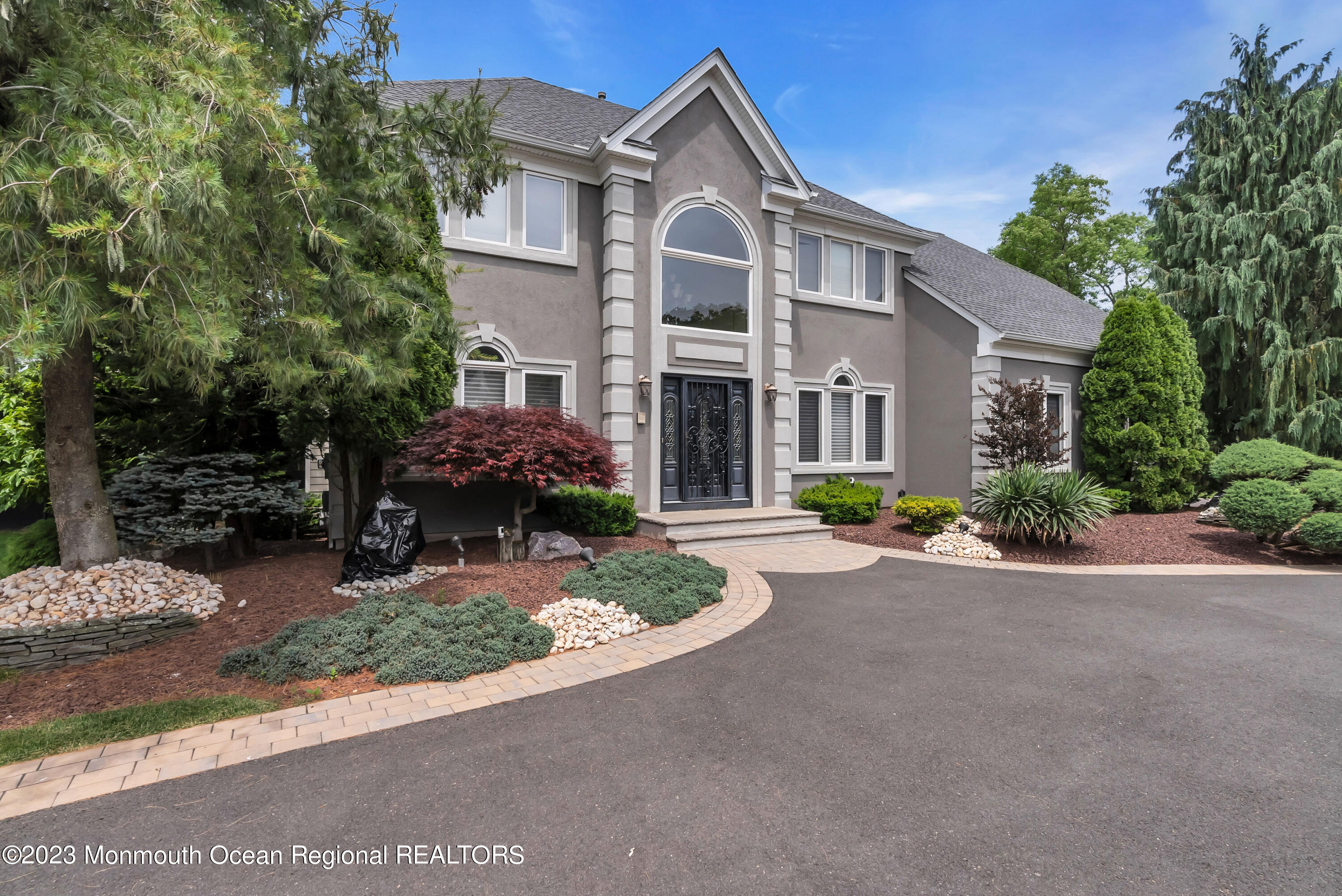 7 MacKenzie Road Eatontown, NJ 07724 - Photo 2 of 42 a front view of a house with porch and outdoor seating