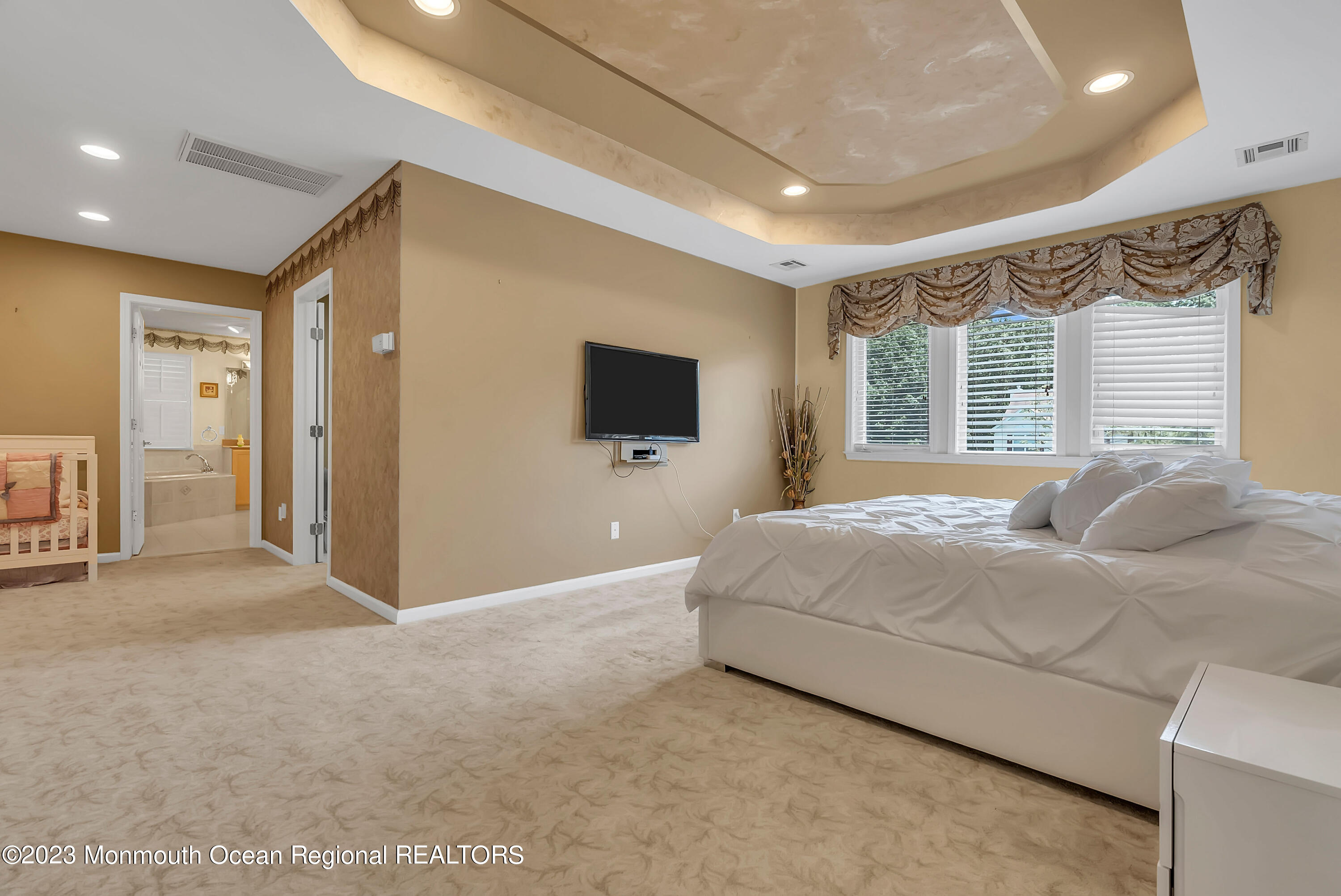 7 MacKenzie Road Eatontown, NJ 07724 - Photo 27 of 42 a spacious bedroom with a large bed and a large window