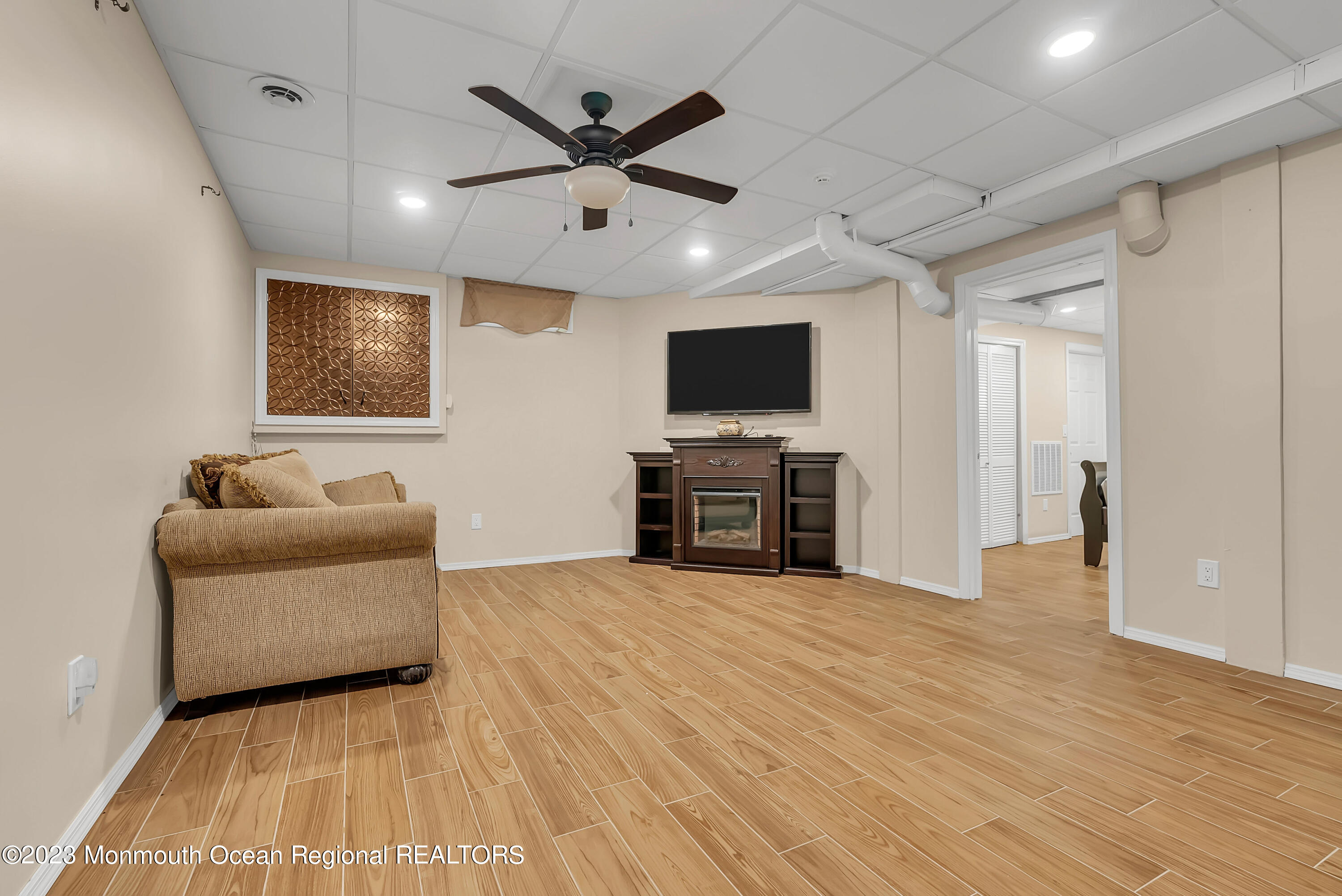 7 MacKenzie Road Eatontown, NJ 07724 - Photo 32 of 42 a living room with furniture and a flat screen tv