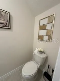 a white toilet sitting next to a bathroom sink and vanity