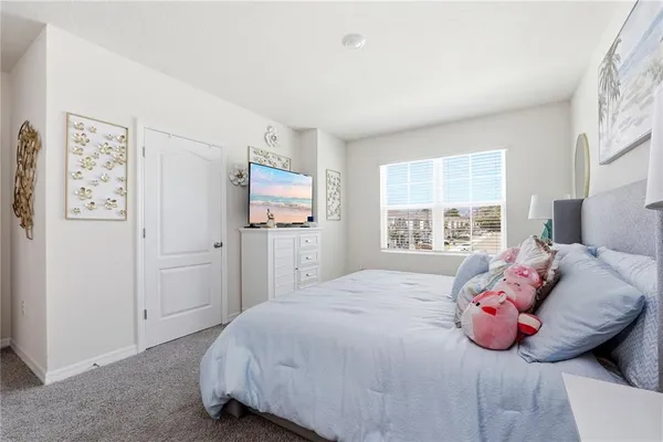 a bedroom with a bed and window