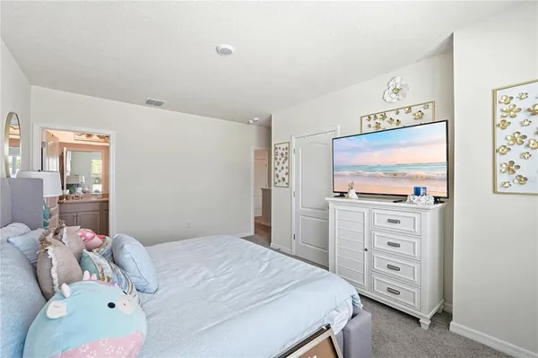 a bedroom with a bed and a dresser