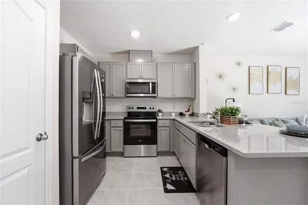 a kitchen with a sink stainless steel appliances and cabinets