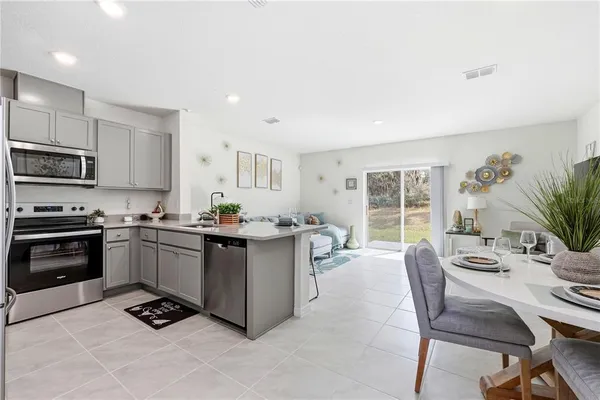 a kitchen with counter top space cabinets and appliances