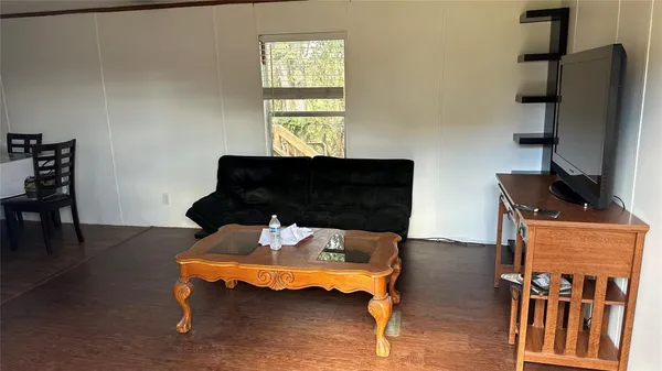 a bedroom with furniture and a window