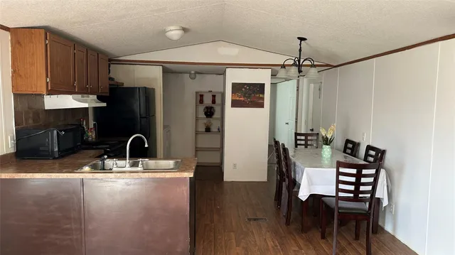 a kitchen with a table chairs and a refrigerator