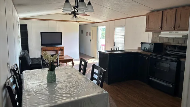 a kitchen with stainless steel appliances granite countertop a stove a sink dishwasher and a microwave oven with cabinets