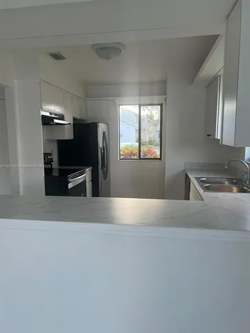 a view of kitchen and windows