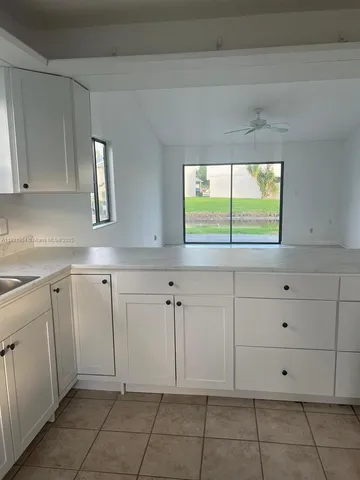 an empty room with a fireplace and a window