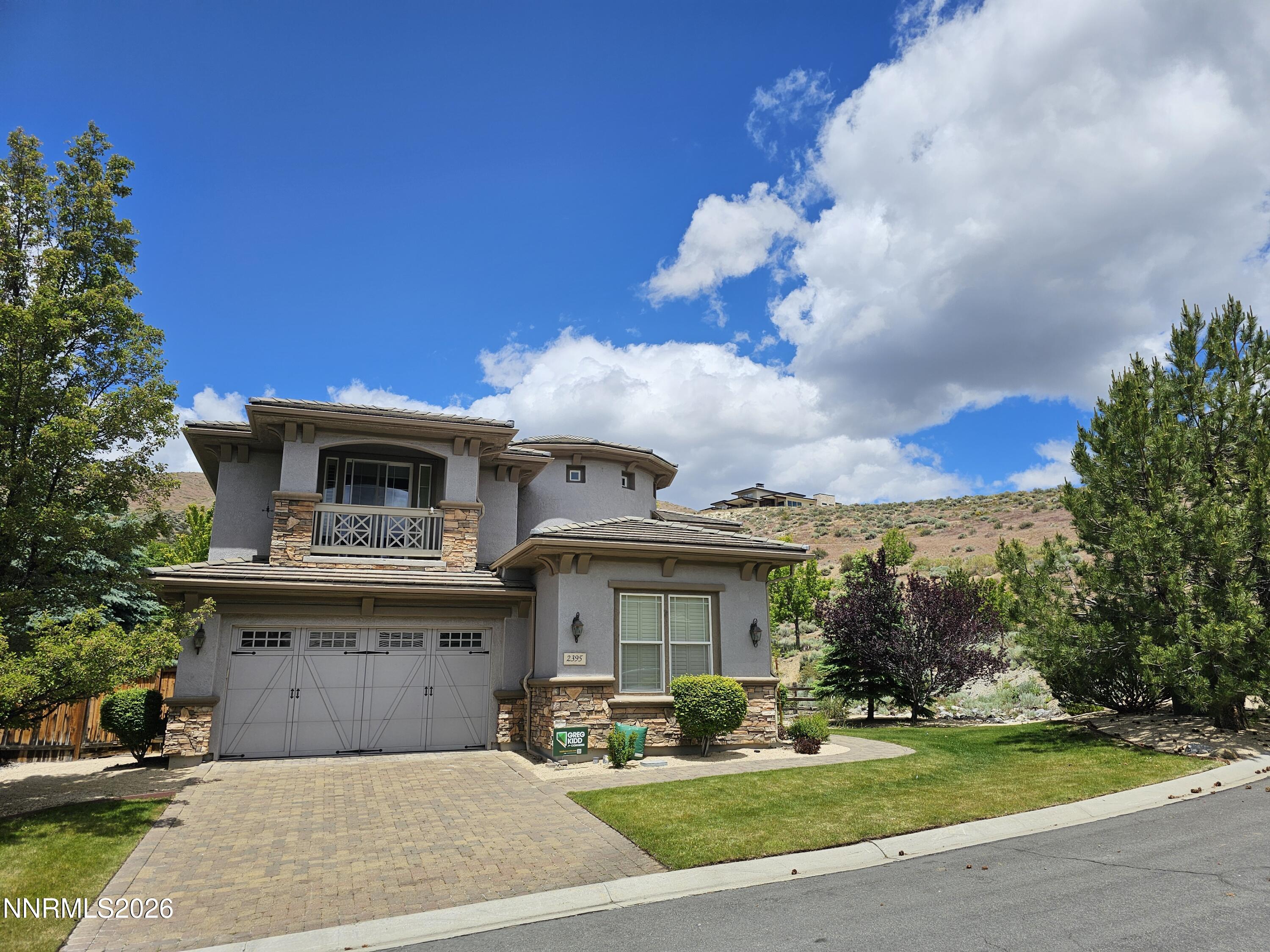 2395 Ridge Field Trail Reno, NV 89523 - Photo 2 of 44 a front view of a house with a garden and trees