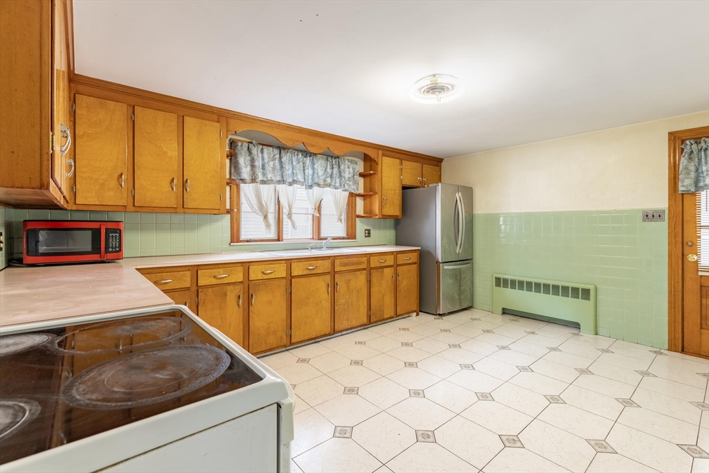 17 Albert Park Everett, MA 02149 - Photo 14 of 40 a kitchen that has a sink and a stove in it