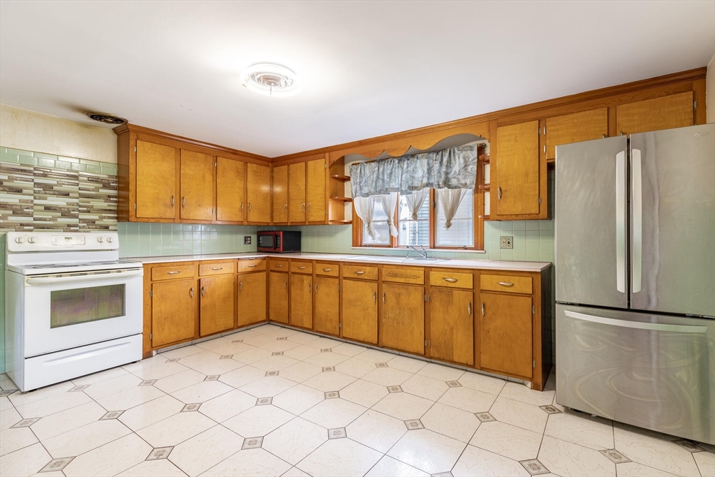 17 Albert Park Everett, MA 02149 - Photo 15 of 40 a kitchen with stainless steel appliances granite countertop a refrigerator sink and cabinets