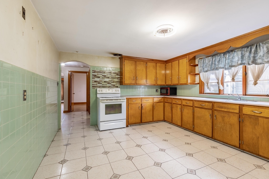 17 Albert Park Everett, MA 02149 - Photo 16 of 40 a kitchen with stainless steel appliances granite countertop a stove sink and cabinets