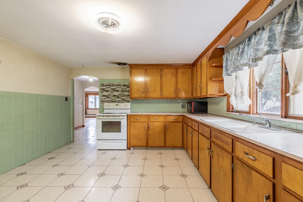 17 Albert Park Everett, MA 02149 - Photo 17 of 40 a large kitchen with a stove top oven sink and cabinets