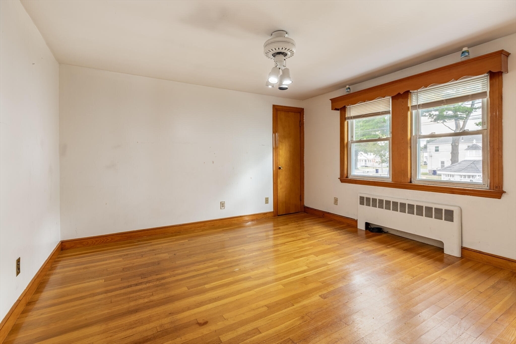 17 Albert Park Everett, MA 02149 - Photo 22 of 40 an empty room with wooden floor and windows