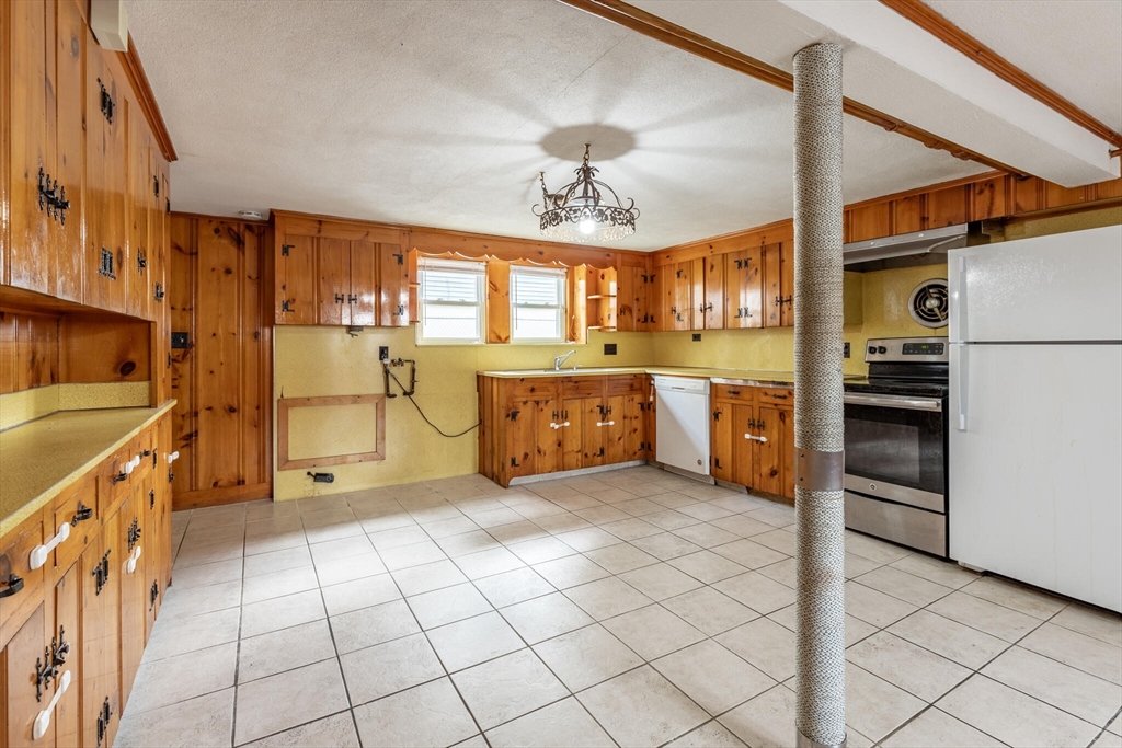17 Albert Park Everett, MA 02149 - Photo 25 of 40 a kitchen with stainless steel appliances kitchen island granite countertop a refrigerator and a stove