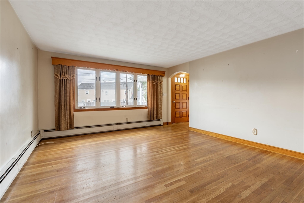 17 Albert Park Everett, MA 02149 - Photo 10 of 40 a view of an empty room with wooden floor and a window