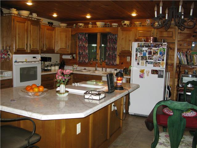 19 Slaterock Mill Road Taft, TN 38488 - Photo 15 of 20 a kitchen with stainless steel appliances granite countertop a sink a stove and a refrigerator