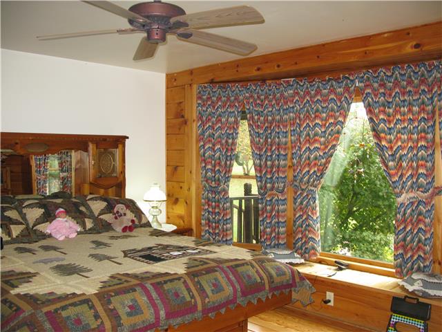 19 Slaterock Mill Road Taft, TN 38488 - Photo 10 of 20 a bedroom with a bed and window