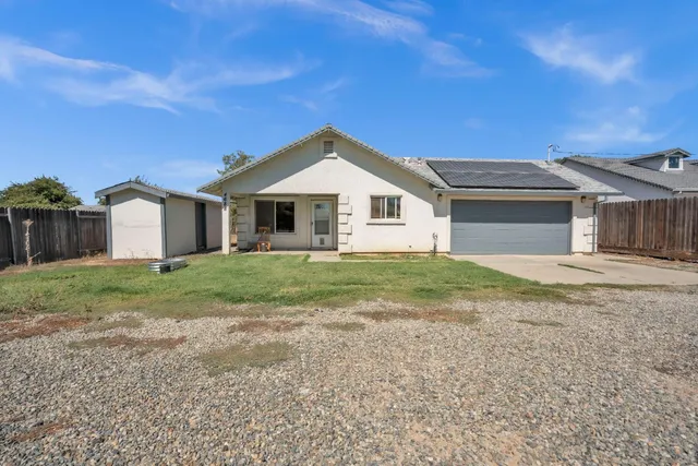 an aerial view of a house with a yard