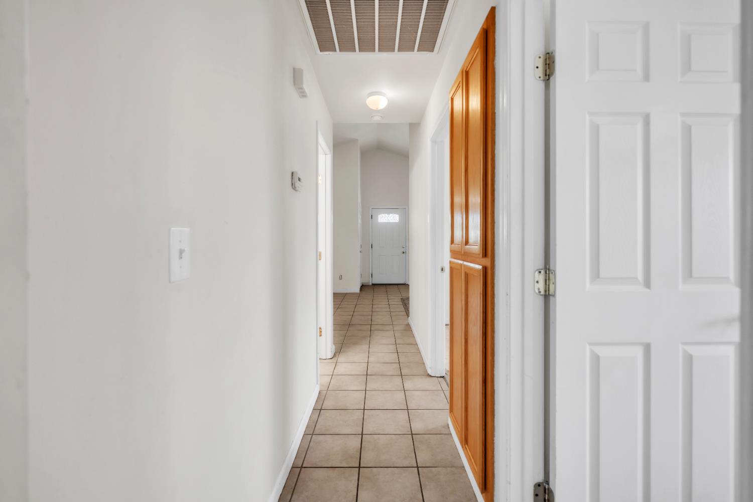 4688 Pacific Avenue Olivehurst, CA 95961 - Photo 35 of 91 a view of a hallway with wooden floor and a bathroom