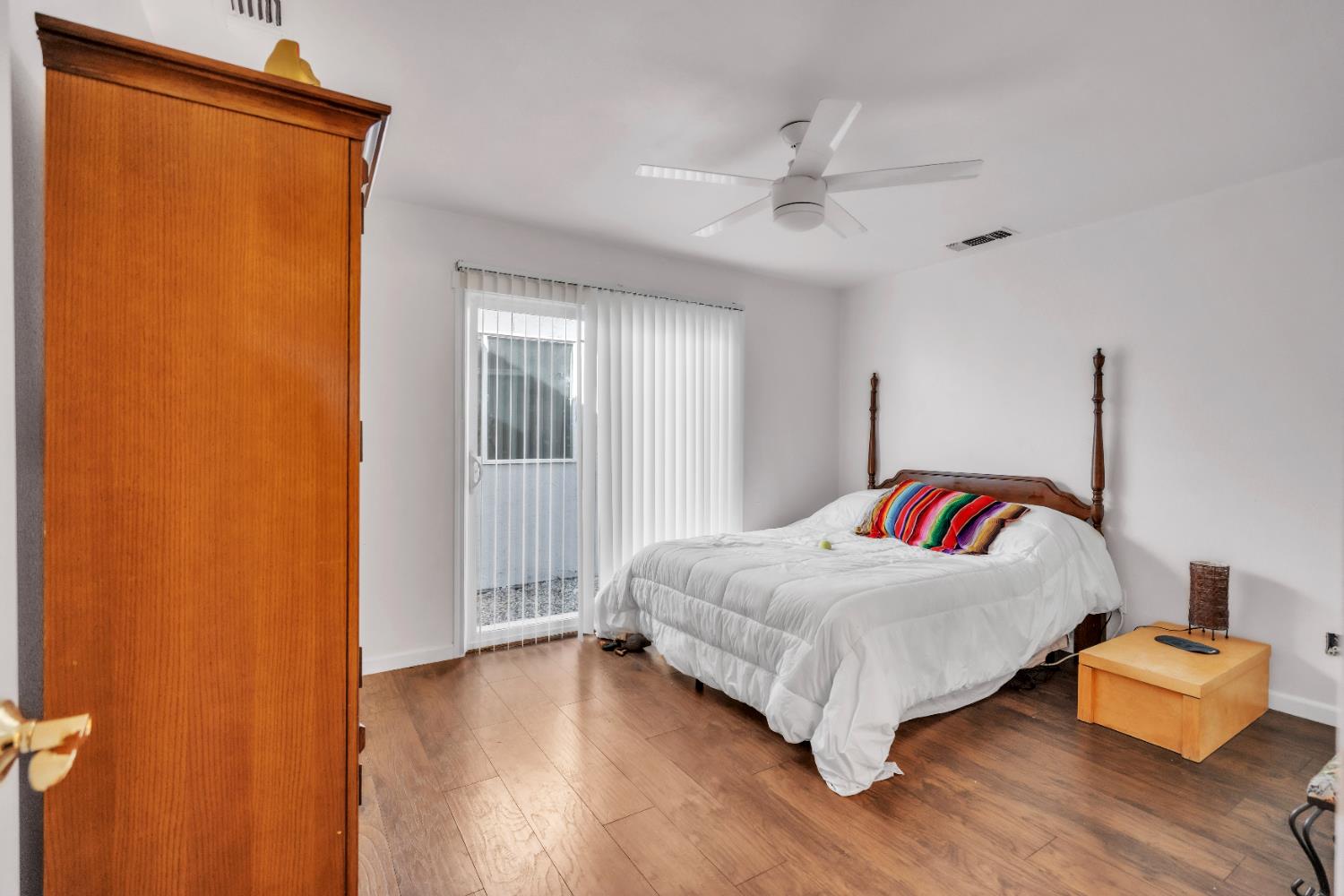 4688 Pacific Avenue Olivehurst, CA 95961 - Photo 36 of 91 a bedroom with a bed and wooden floor