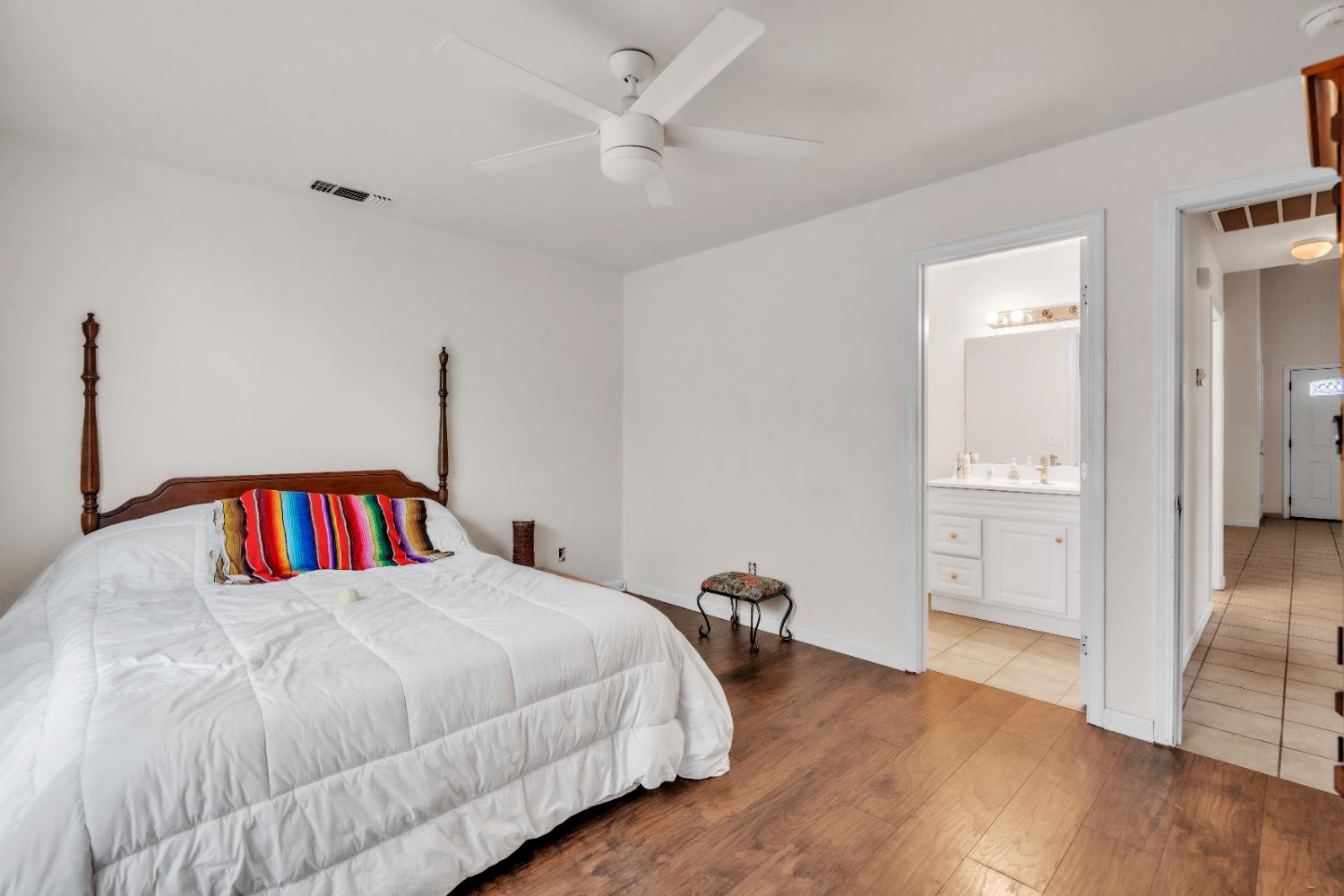 4688 Pacific Avenue Olivehurst, CA 95961 - Photo 37 of 91 a bedroom with a large bed and a chandelier