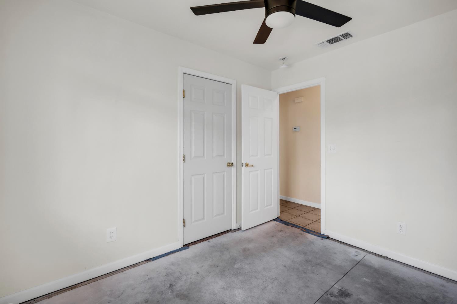 4688 Pacific Avenue Olivehurst, CA 95961 - Photo 41 of 91 an empty room with a ceiling fan and a window