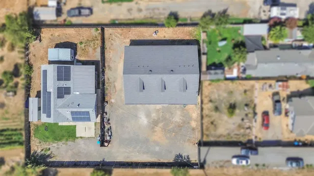 an aerial view of a house with a lake view