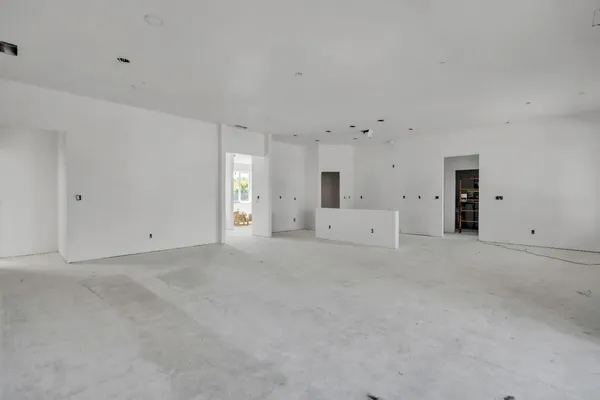 a view of an empty room with a window and a ceiling fan