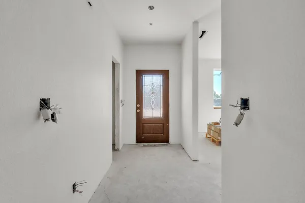 an empty room that has a painting on the wall