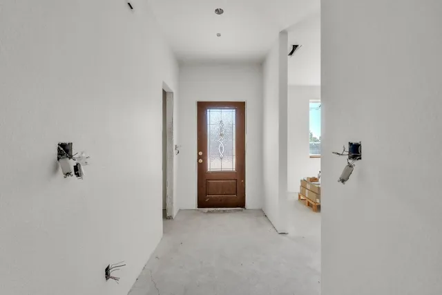 an empty room that has a painting on the wall