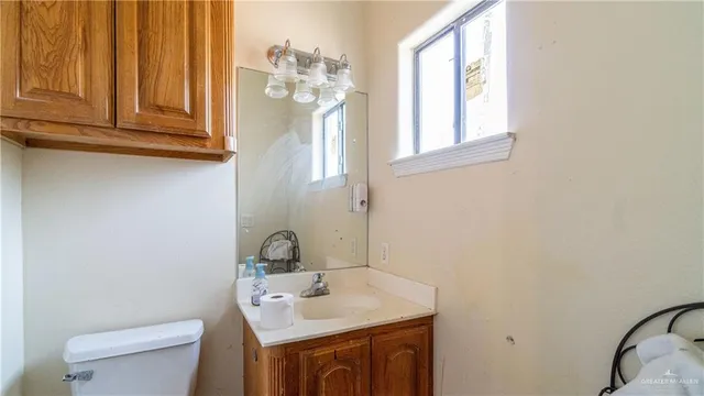 a bathroom with a sink a toilet and mirror