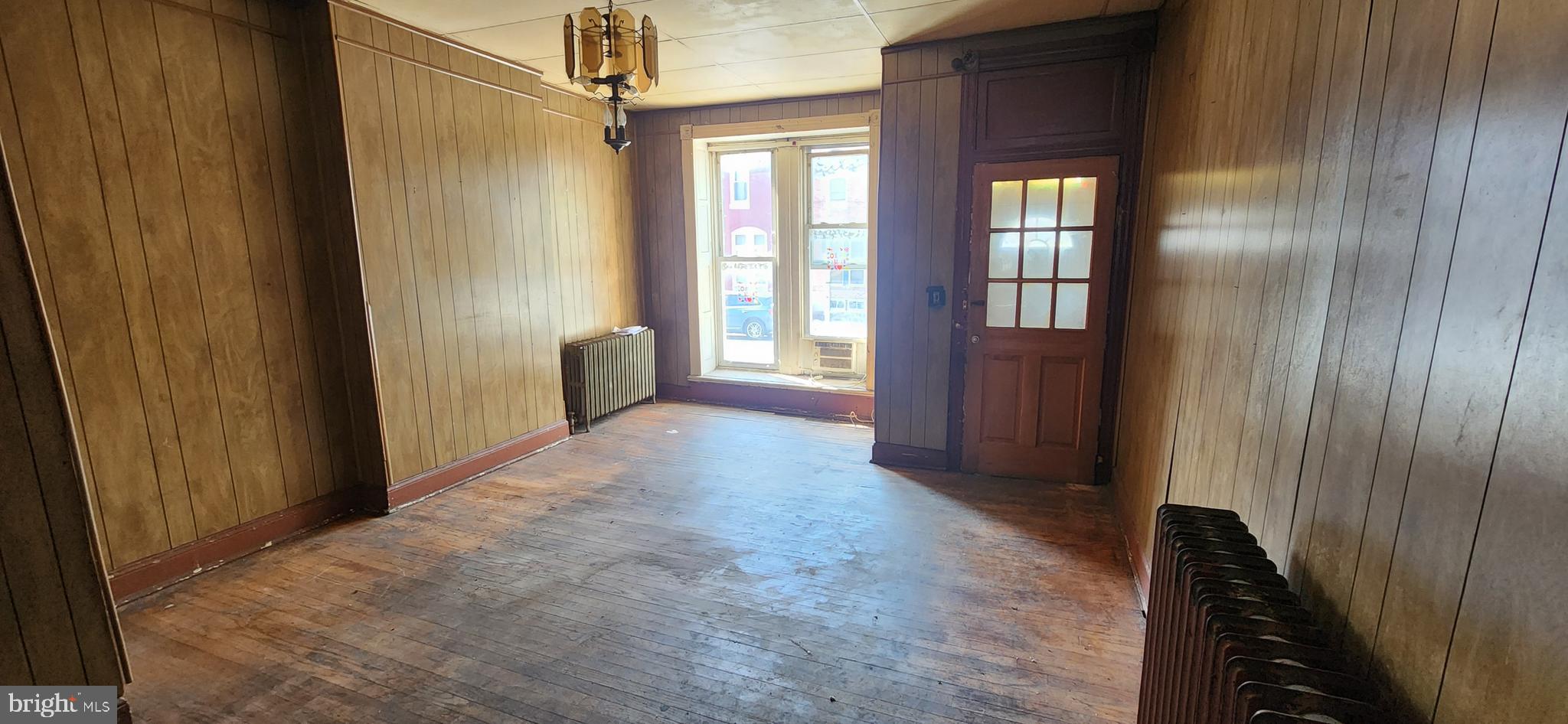 1746 East Oliver Street Baltimore, MD 21213 - Photo 4 of 17 a view of entryway with window and wooden floor
