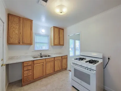 a kitchen with cabinets and white appliances