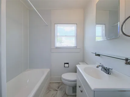 a bathroom with a sink a toilet and a bathtub
