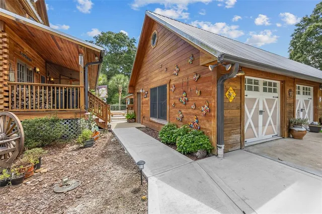 a view of a house with swimming pool and sitting area