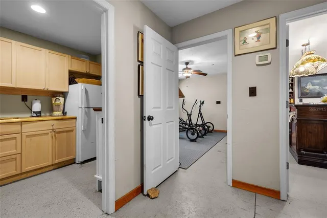 a view of a chair and table in backyard of the house