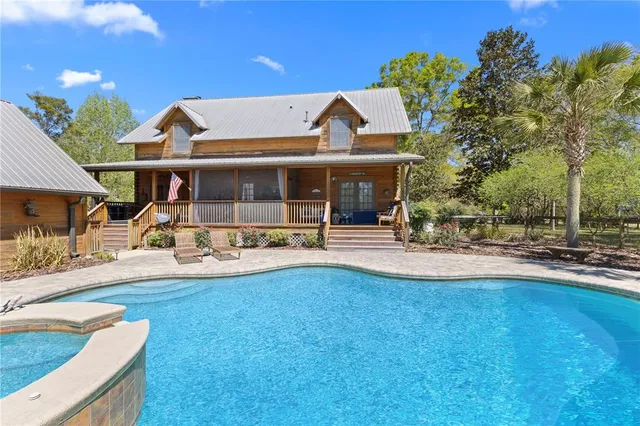 a bathroom with a sink and mirror with bathtub