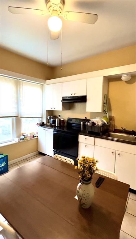 a kitchen with a sink cabinets and window