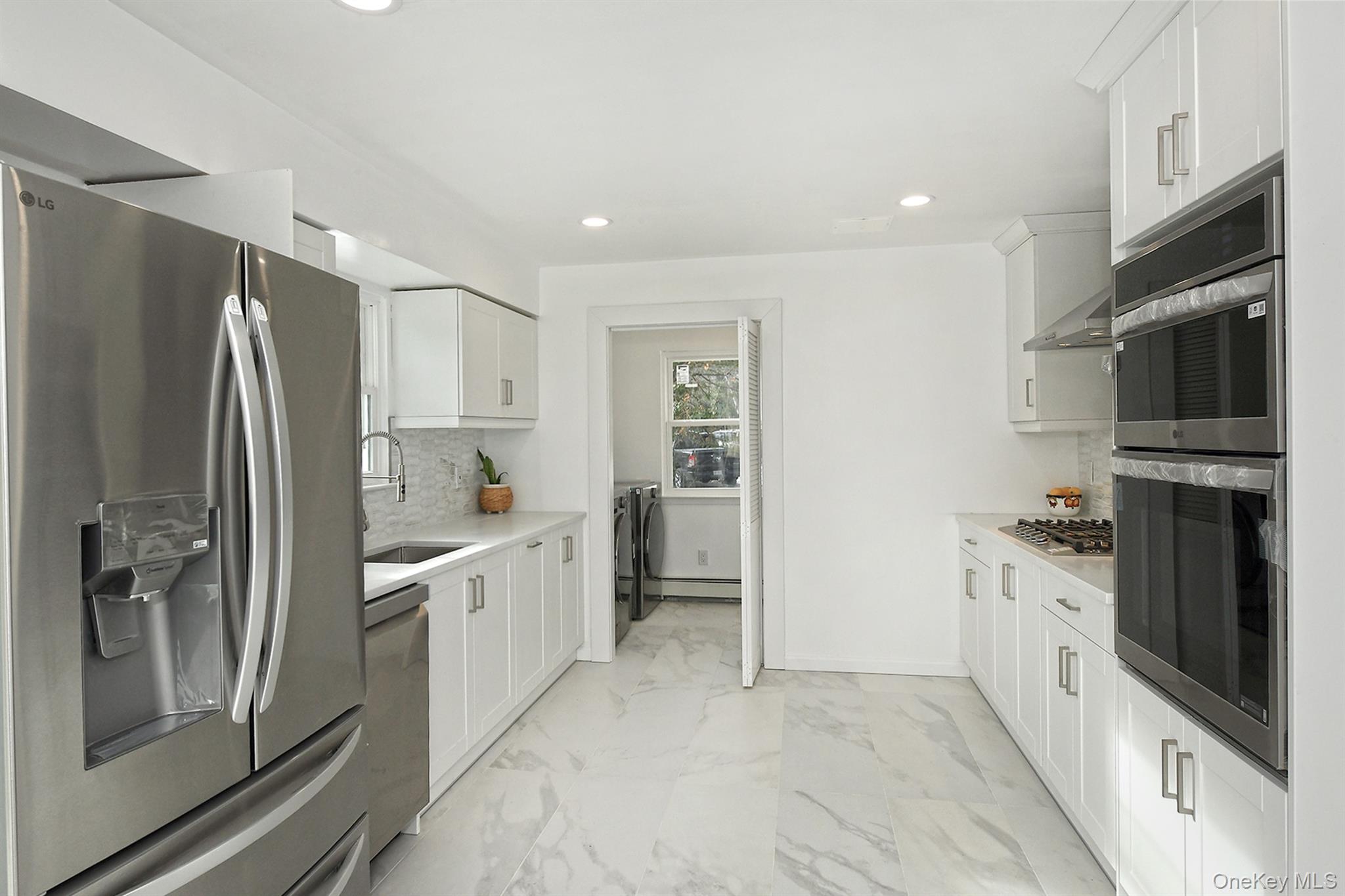 34 Warner Road Huntington, NY 11743 - Photo 12 of 39 a kitchen with stainless steel appliances a refrigerator sink and stove